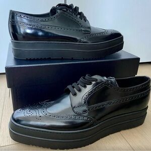 Prada men’s Spazzolato Black Leather Wingtip Brogues